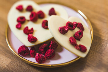 Craft premium heart-shaped white chocolate with dry raspberry. High quality photo