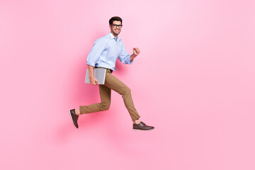 Fototapeta na wymiar Full body length photo of jumping running with netbook funky guy need charge his new hp computer satisfied worker isolated on pink color background