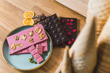 High-quality craft chocolate bars of fruit and nut flavors on a plate . High quality photo