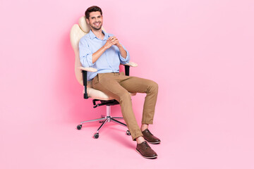 Full length photo of positive confident man sitting comfort chair relax rest break pause empty...