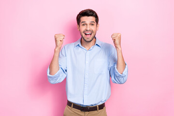 Fototapeta premium Photo of overjoyed man raise hand rejoice support favorite team win lottery money gambling isolated on pink color background