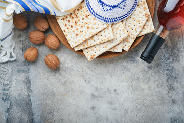 Passover celebration concept. Matzah, red kosher and walnut. Traditional ritual Jewish bread matzah, kippah and tallit on old concrete background. Passover food. Pesach Jewish holiday. - obrazy, fototapety, plakaty