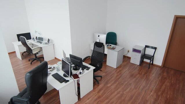 High Angle View Wide No People Shot Of Modern Open Plan Office With Desks And Computers