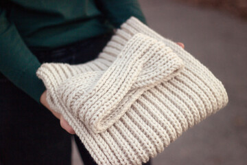Knitted beige wool snood and headband. Knitting and hobby concept. DIY 