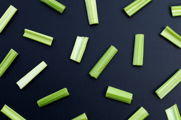 Fresh celery on dark background. Top view