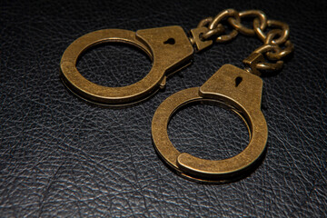 image of handcuffs leather background
