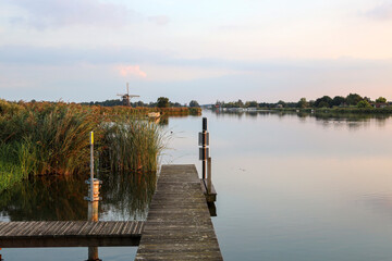 Fototapeta premium Sunset over river Rotte at the Tweemanspolder in Zevenhuizen