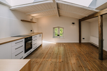 White and brown modern kitchen with wooden island