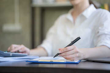 Close-up hand businesswomen using a pen for work.