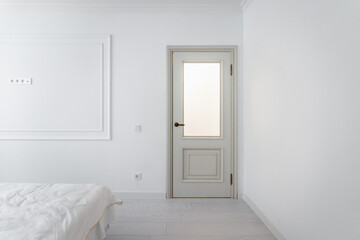 Fototapeta na wymiar Corridor in with white walls and doors in the apartment