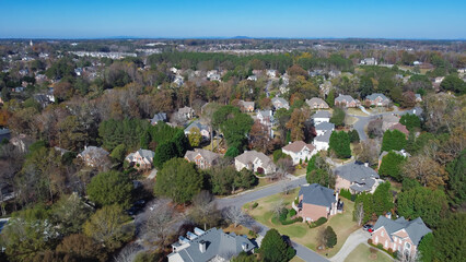 Chestnut mountain in far background and row of upscale two-story house with shingle roof and lush...