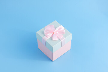 Gift in a beautiful package, box with gifts, attributes festive mood, gift on a blue background