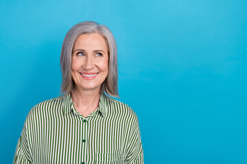 Photo of positive attractive funny old business lady wear green shirt cheerful white hair smile look mockup promo isolated on blue color background