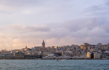Fototapeta premium sunset view in istanbul bosphorus. Red sunset in Istanbul. Historical Galata tower and istanbul silhouette. View of the Galata Tower in Beyoglu district at sunset along the Golden Horn in Istanbul.