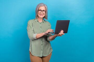 Photo of successful positive lady hold use wireless netbook networking isolated on blue color...
