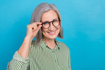 Plakat Portrait photo of retired ceo company worker woman touch glasses specs smiling wear striped shirt good vision isolated on blue color background