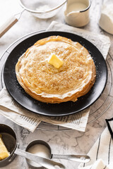 pancakes with butter on a white background with ingredients flour sugar butter