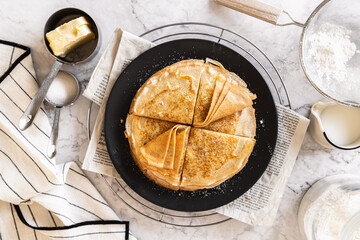 pancakes with butter on a white background with ingredients flour sugar butter