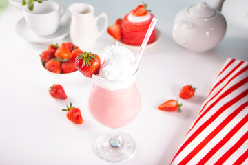 Glass of strawberry milkshake or smoothie. Summer healthy vitamin beverage, diet or vegan food