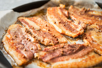 Whole pork belly grilled in an oven pan	