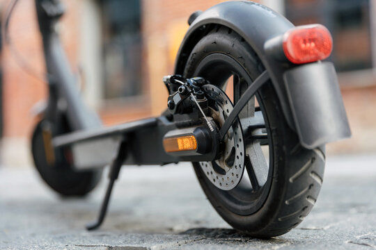 Close up view on electric scooter rear wheel in urban street