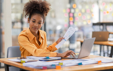 Attractive african young confident businesswoman Accounting using calculating income-expenditure...