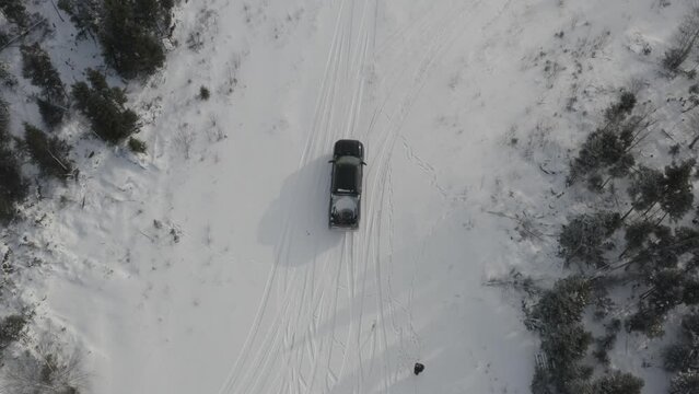 Truck driving on snow drone shot