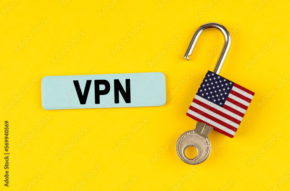 Poster on the yellow surface is an open lock with a key and a sticker with the inscription - vpn