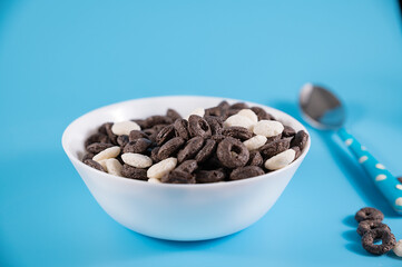 Oreo Flavored Breakfast Cereal, black and white dry breakfast rings. Cup with delicious breakfast...