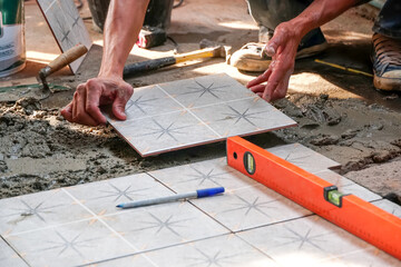 Floor tiles installation. Ceramic tiles and tools for tiler. Home improvement, renovation - ceramic...