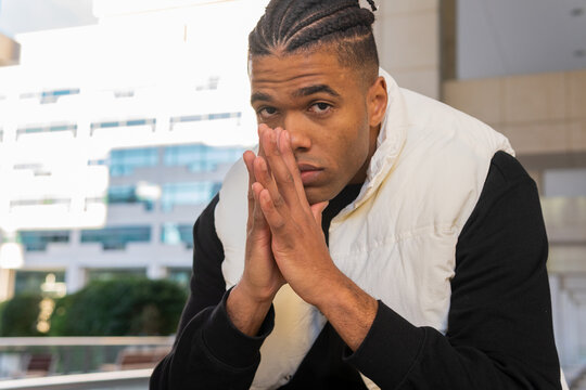 Thoughtful black man with praying hands