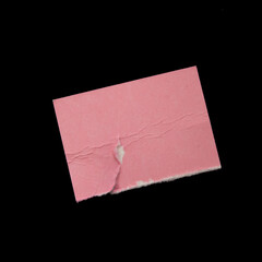 Pink torn paper piece on black background