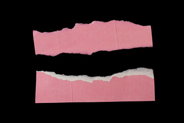 Torn pink paper piece isolated on black background