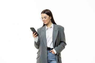 Portrait of a happy a businesswoman holding mobile phone and looking away isolated over white background