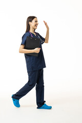 Young happy smiling female doctor or scientist in blue coat walking