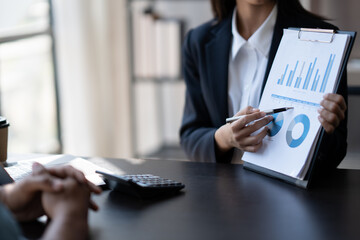 Young smart businesswoman explaining her ideas of the project to her male coworker at the office.