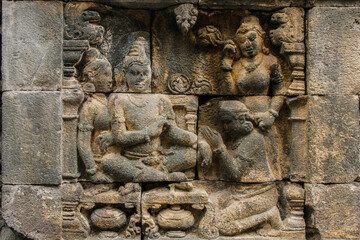 A fragment of the Borobudur Temple wall carvings with Buddha. Central Java, Indonesia.