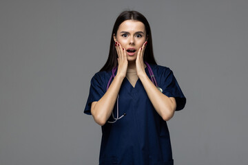 Shocked female doctor covers her lips with hands, close mouth and looking worried, taboo gesture,...