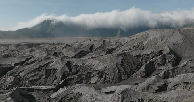 Aerial Scenic Shot Of Tranquil Mountain Under Mountains, Drone Flying Forward Over Dramatic Landscape - Java, Indonesia