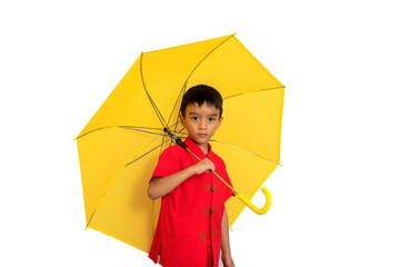 boy fashion  wearing a Chinese-style shirt holding a yellow umbrella poses for a photo shoot.