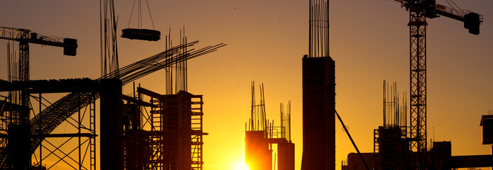 Silhouette of the modern construction site during a summer sunset