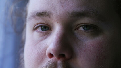 Obraz premium Young man close up eyes looking at camera. One caucasian casual person with natural expression macro eye