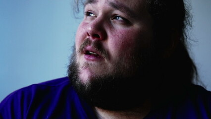 One overweight man with preoccupied expression close up face