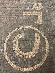 Wheelchair accessible symbol made from cobblestones