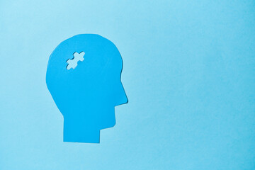 Alzheimer's disease, senile dementia and memory loss. Head silhouette with jigsaw puzzle