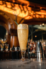 Orange cocktail with garnish and pineapple