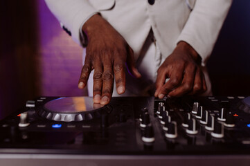 hands control the remote control. setting the remote control knob. electronic device of the mixer...
