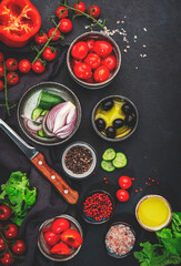 Vegetables, olives, oil and ingredients for cooking greek salad with feta cheese, cherry tomato, paprika, cucumber and red onion, healthy mediterranean food, low calories eating.