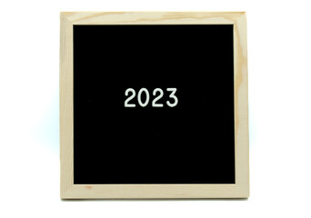 2023 on black wood frame on white background