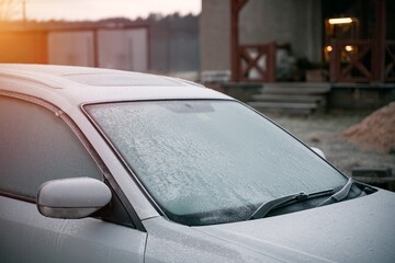 frozen windshield wiper. concept of dangerous driving during the winter season.